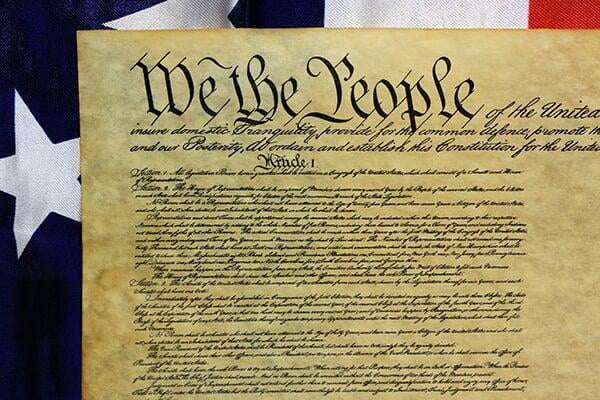 United States Constitution, "We the People", U.S. Flag background.